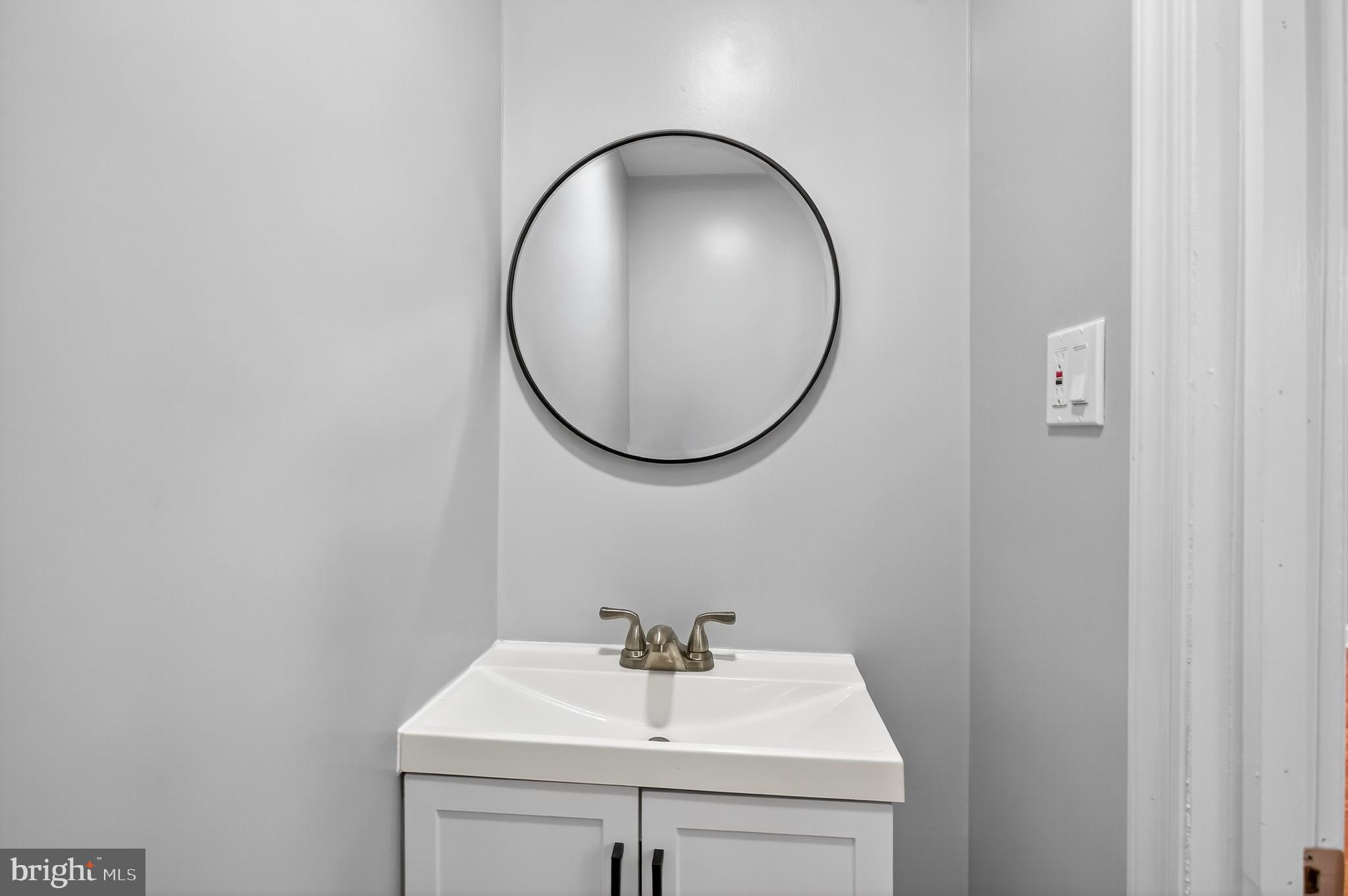 6351 Reedland Street Philadelphia, PA 19142 - Photo 14 of 30 a bathroom with a sink and a mirror