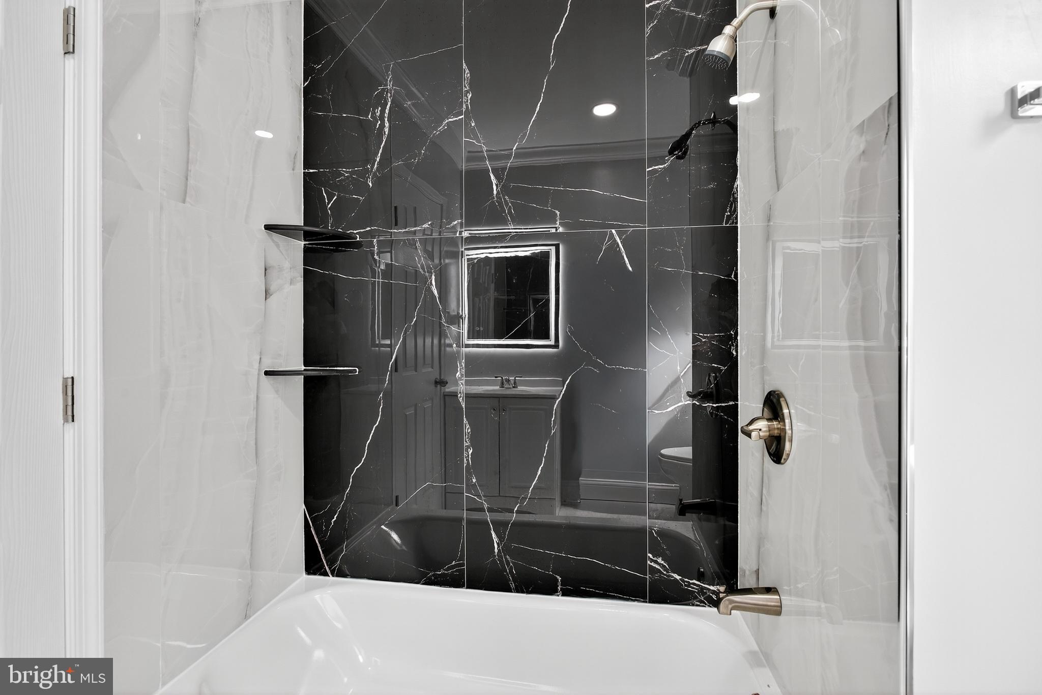 6351 Reedland Street Philadelphia, PA 19142 - Photo 19 of 30 a bathroom with a bathtub and a shower