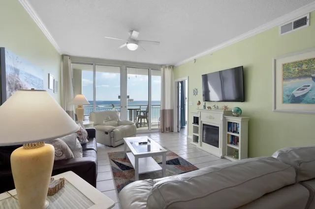 a living room with furniture a flat screen tv and a fireplace