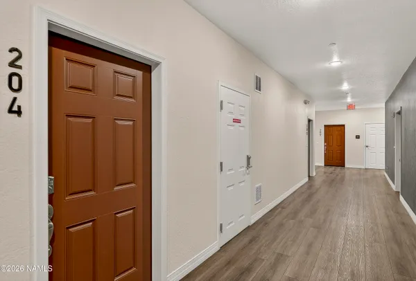 a view of hallway with wooden floor