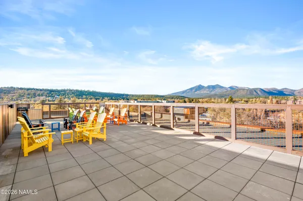 a view of a chairs and table in patio