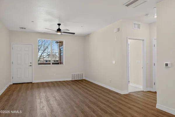 wooden floor in an empty room with a window