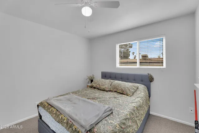 a bedroom with a bed and window