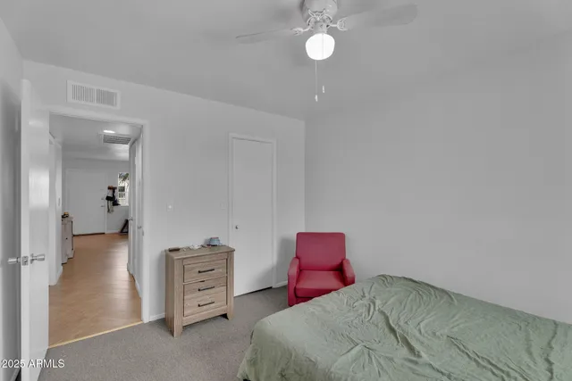 a bedroom with a bed mirror and window