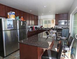 Undisclosed Address Isla Vista, CA 93117 - Photo 11 of 16 a kitchen with stainless steel appliances granite countertop a refrigerator a stove a sink a dining table and chairs