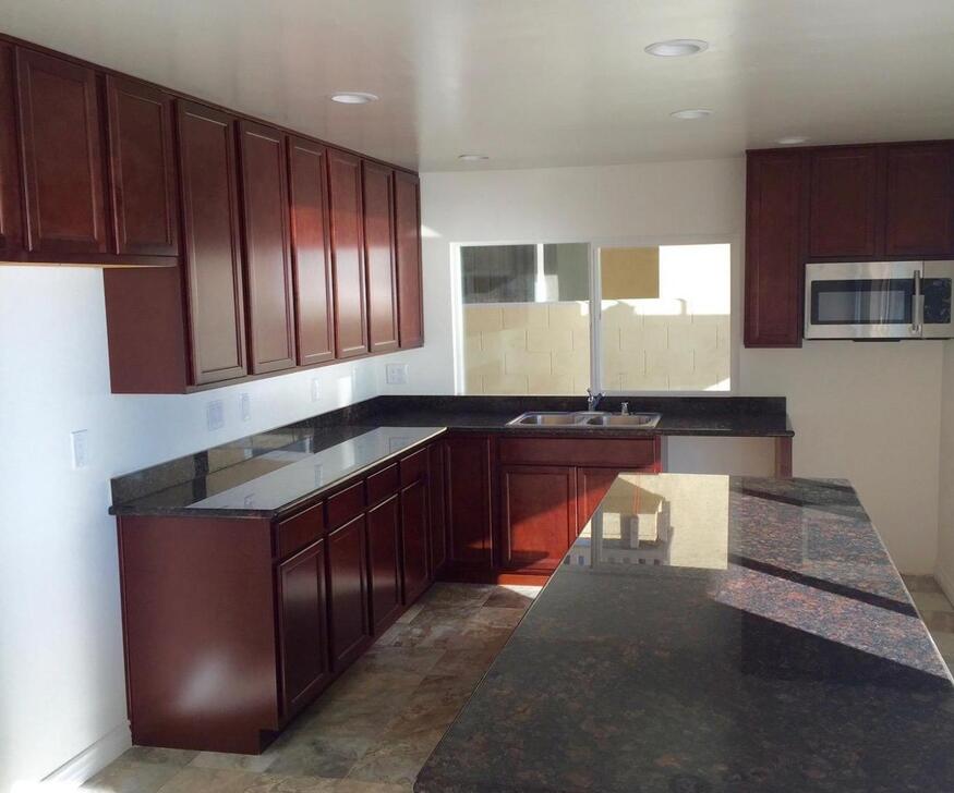 Undisclosed Address Isla Vista, CA 93117 - Photo 12 of 16 a kitchen with kitchen island granite countertop wooden cabinets and a sink