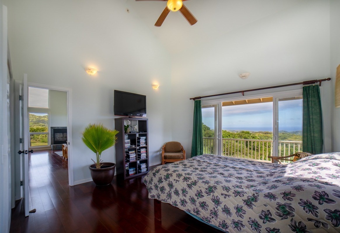 5495 A Puulima Road, Unit D Kalaheo, HI 96741 - Photo 17 of 24 a bedroom with a bed and a flat screen tv