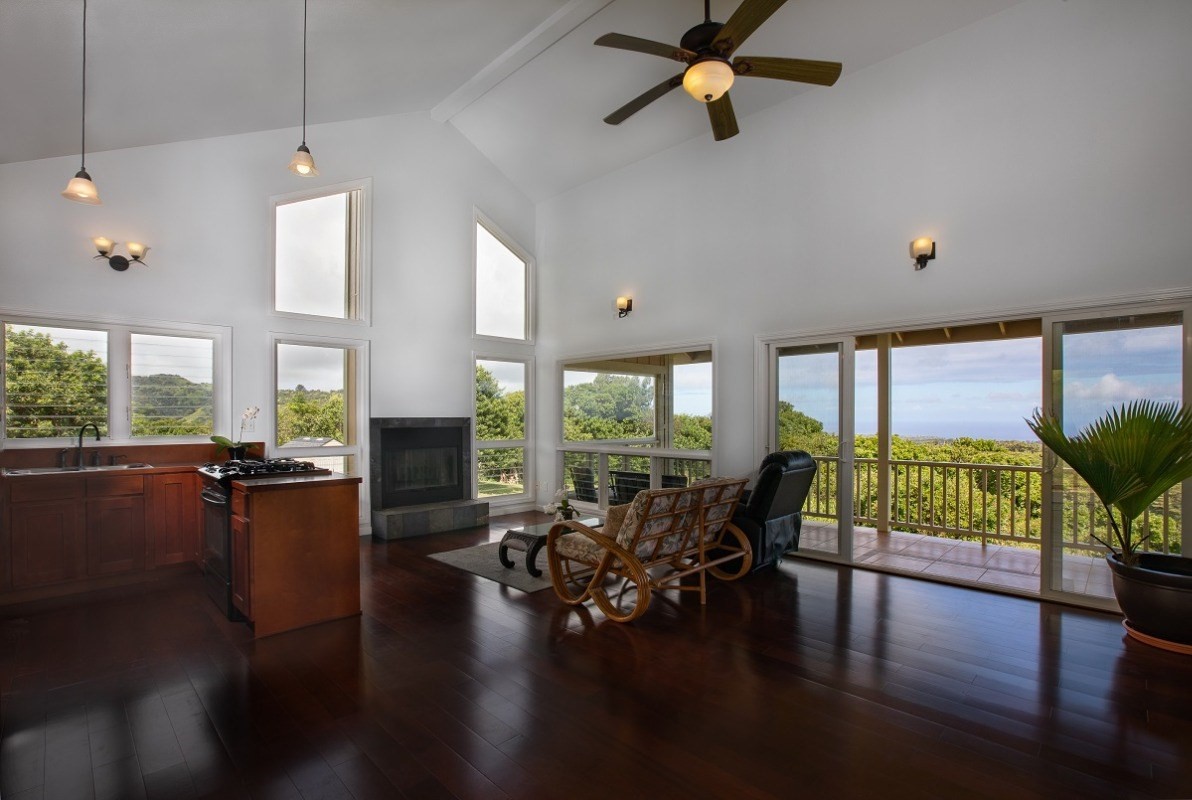 5495 A Puulima Road, Unit D Kalaheo, HI 96741 - Photo 4 of 24 a living room with fireplace furniture and a large window