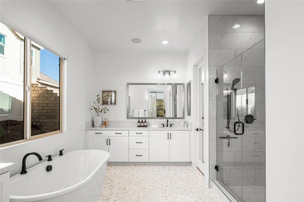 39504 Caladium Drive Temecula, CA 92591 - Photo 13 of 38 a bathroom with a bathtub sink shower and mirror