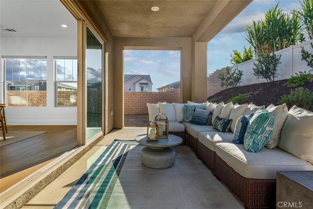 39504 Caladium Drive Temecula, CA 92591 - Photo 28 of 38 a living room with furniture and a floor to ceiling window