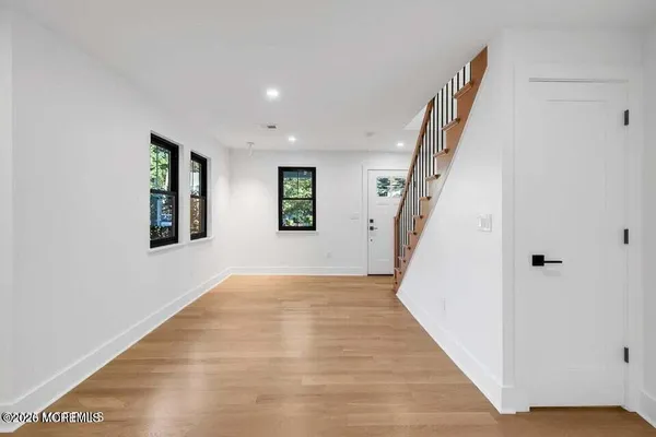 a view of an entryway with wooden floor