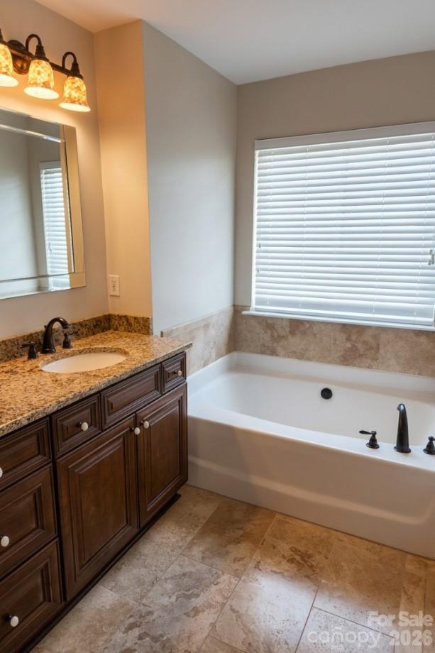 104 Rock Ridge Lane Mount Holly, NC 28120 - Photo 32 of 48 a bathroom with a tub sink and mirror