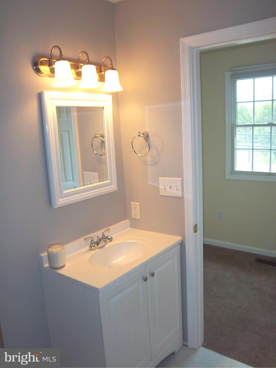 7917 Quarterfield Road Severn, MD 21144 - Photo 12 of 27 a bathroom with a sink vanity granite and a mirror