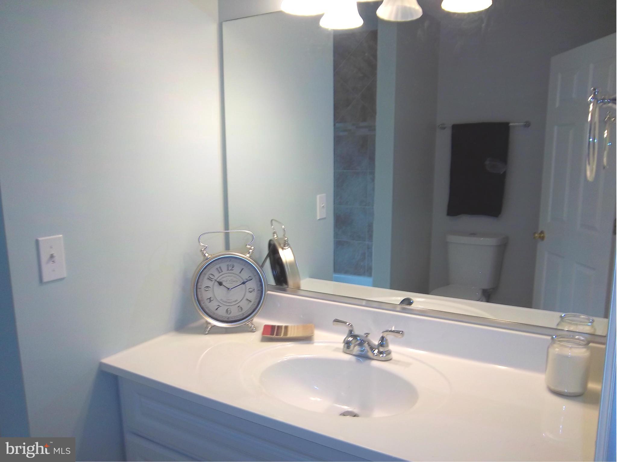 7917 Quarterfield Road Severn, MD 21144 - Photo 15 of 27 a bathroom with a sink and a mirror