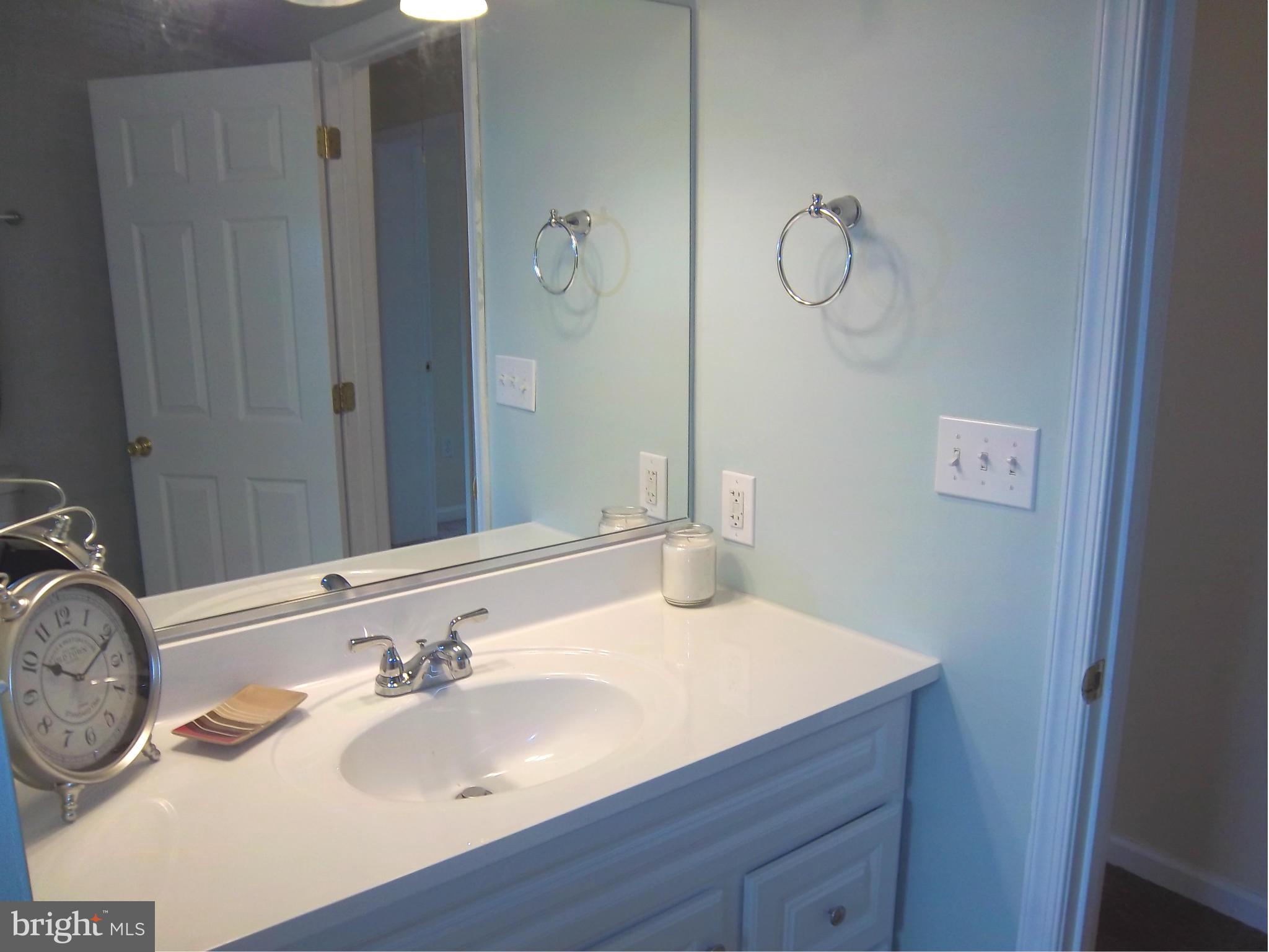 7917 Quarterfield Road Severn, MD 21144 - Photo 16 of 27 a bathroom with a sink and a mirror