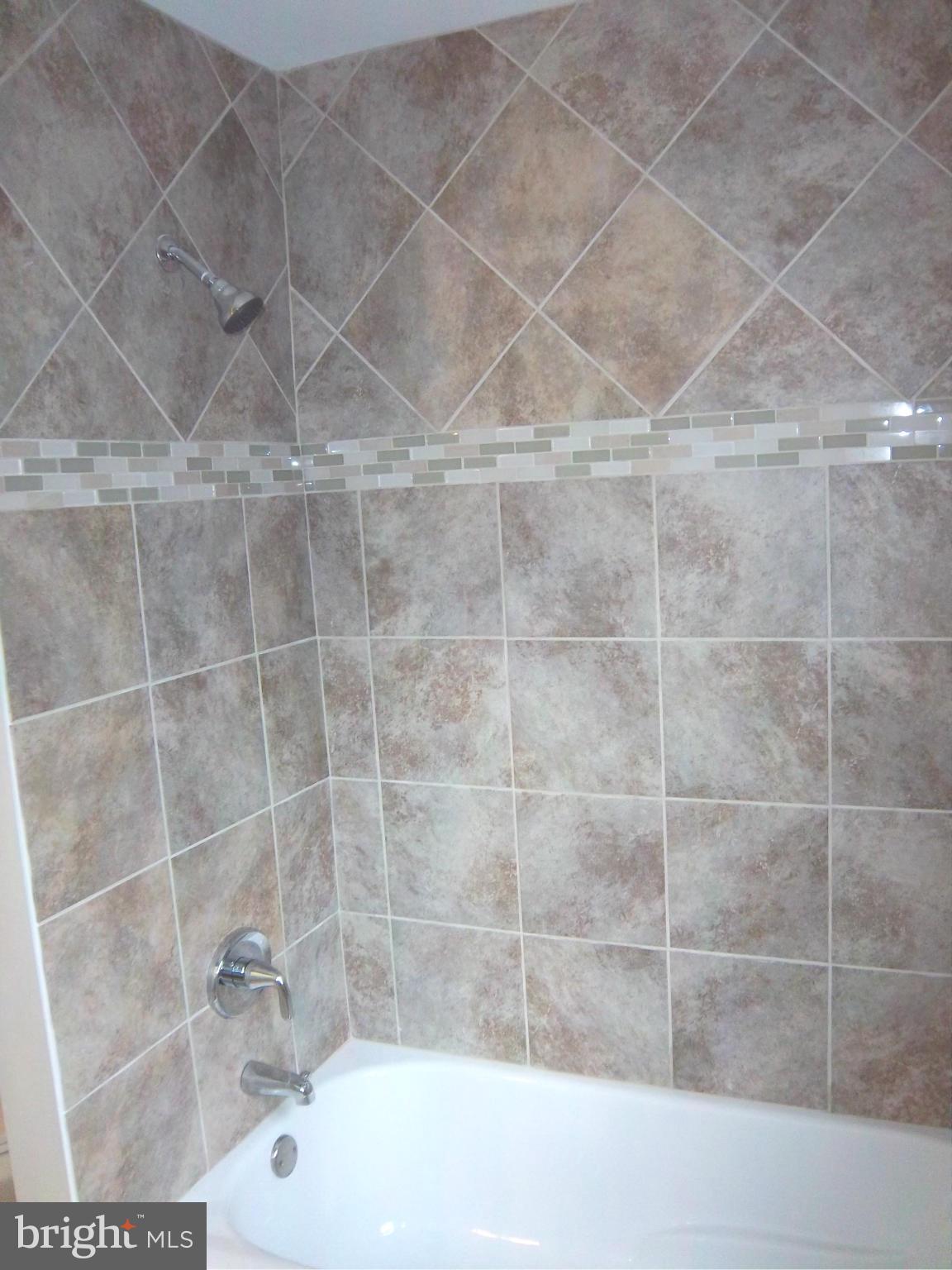 7917 Quarterfield Road Severn, MD 21144 - Photo 17 of 27 a bathroom with a bathtub