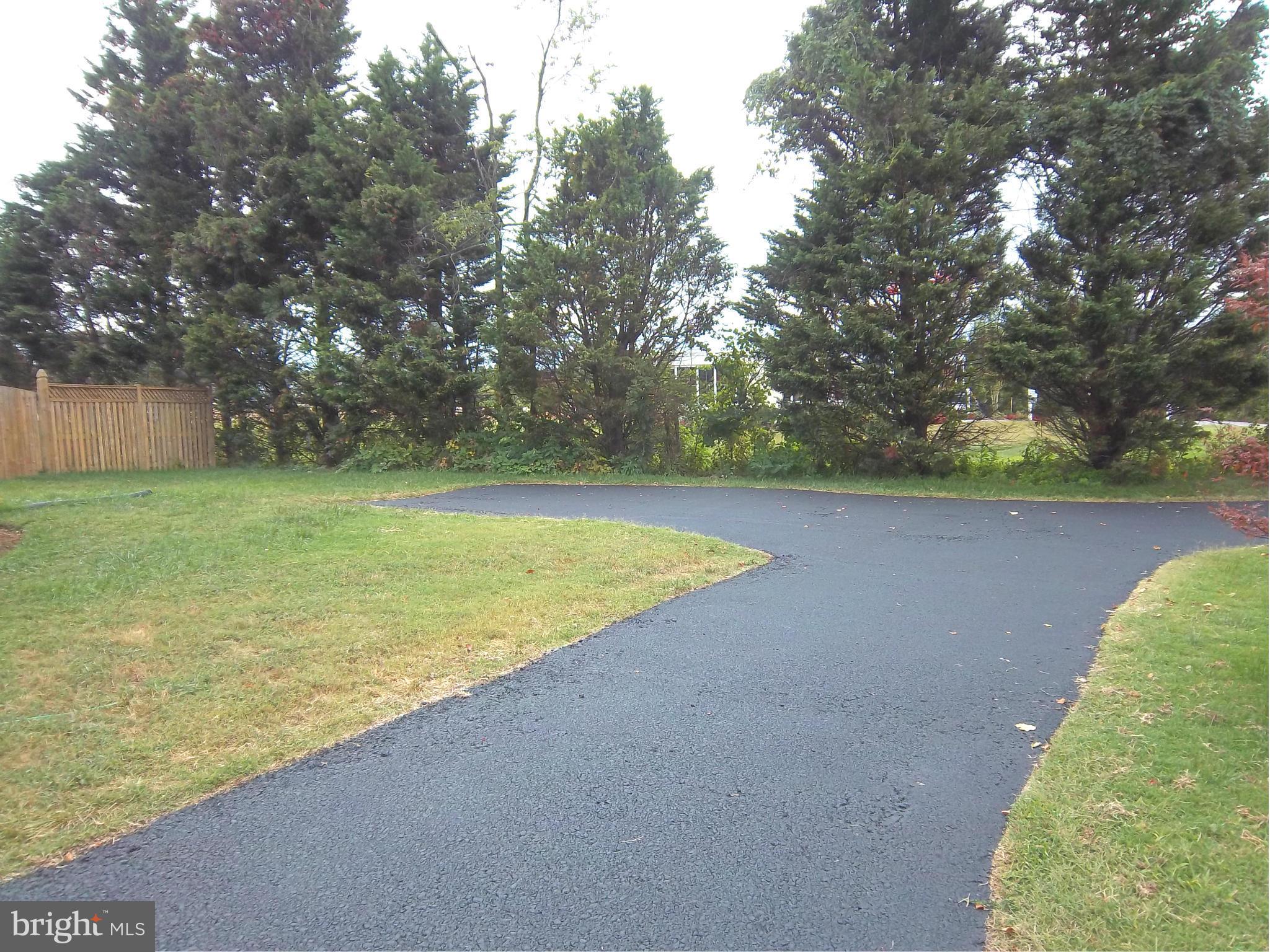7917 Quarterfield Road Severn, MD 21144 - Photo 3 of 27 a view of a lake with a yard and a large tree