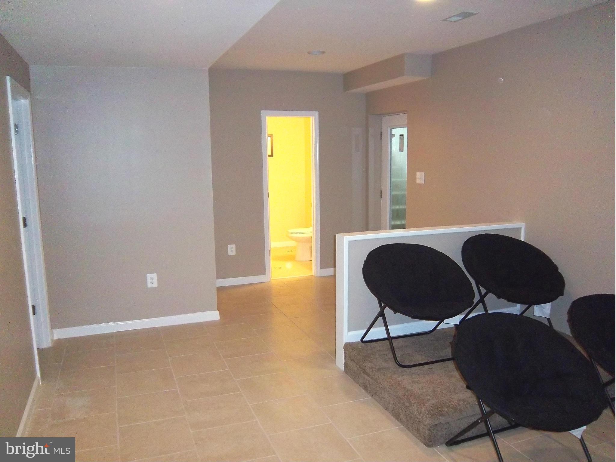 7917 Quarterfield Road Severn, MD 21144 - Photo 23 of 27 a view of a livingroom with chairs and a potted plant