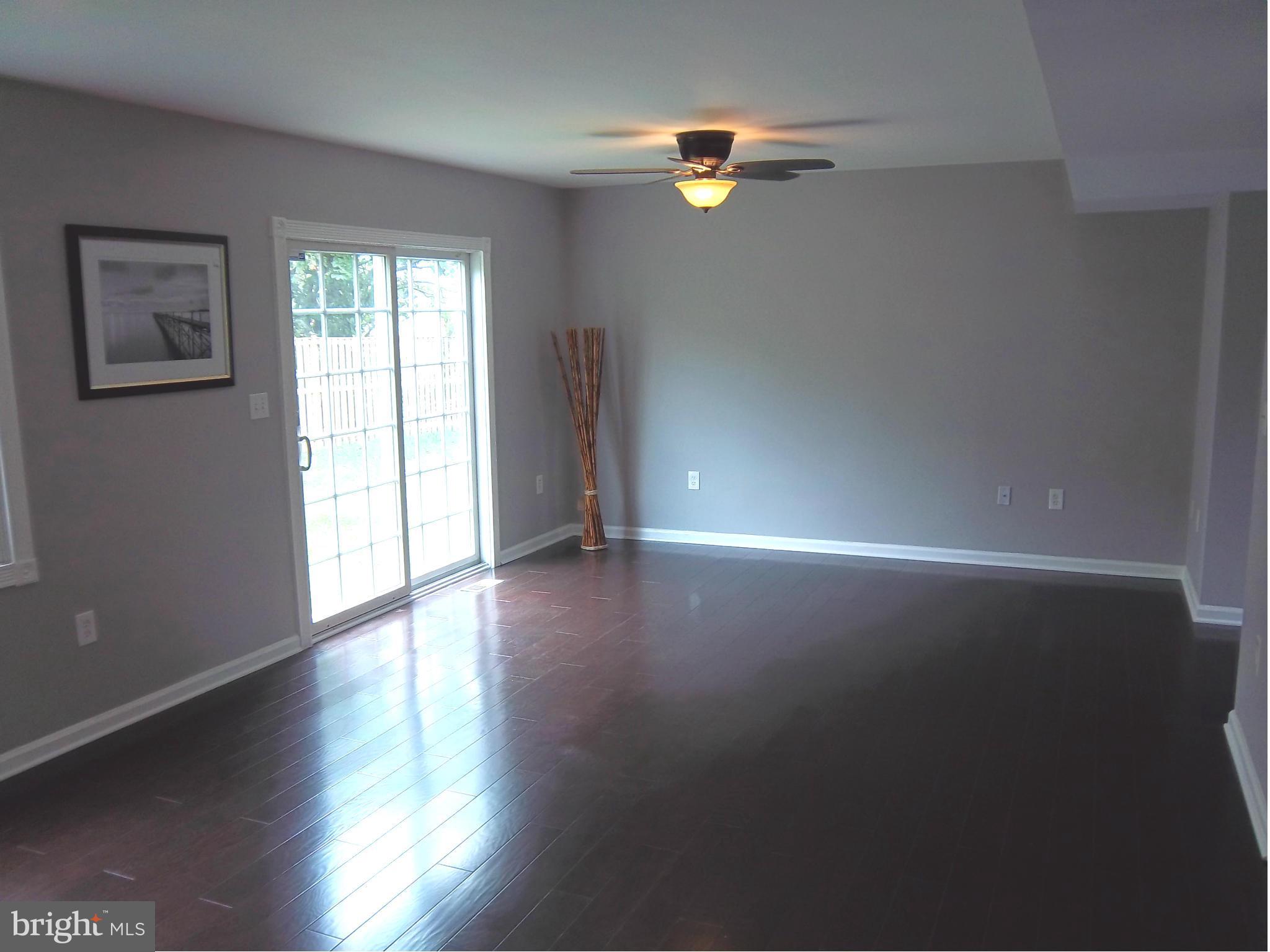 7917 Quarterfield Road Severn, MD 21144 - Photo 6 of 27 a view of a livingroom with wooden floor
