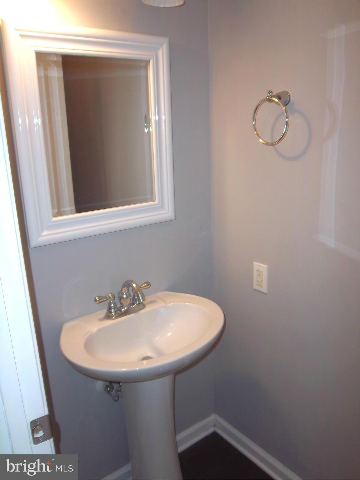 7917 Quarterfield Road Severn, MD 21144 - Photo 7 of 27 a bathroom with a sink and a mirror