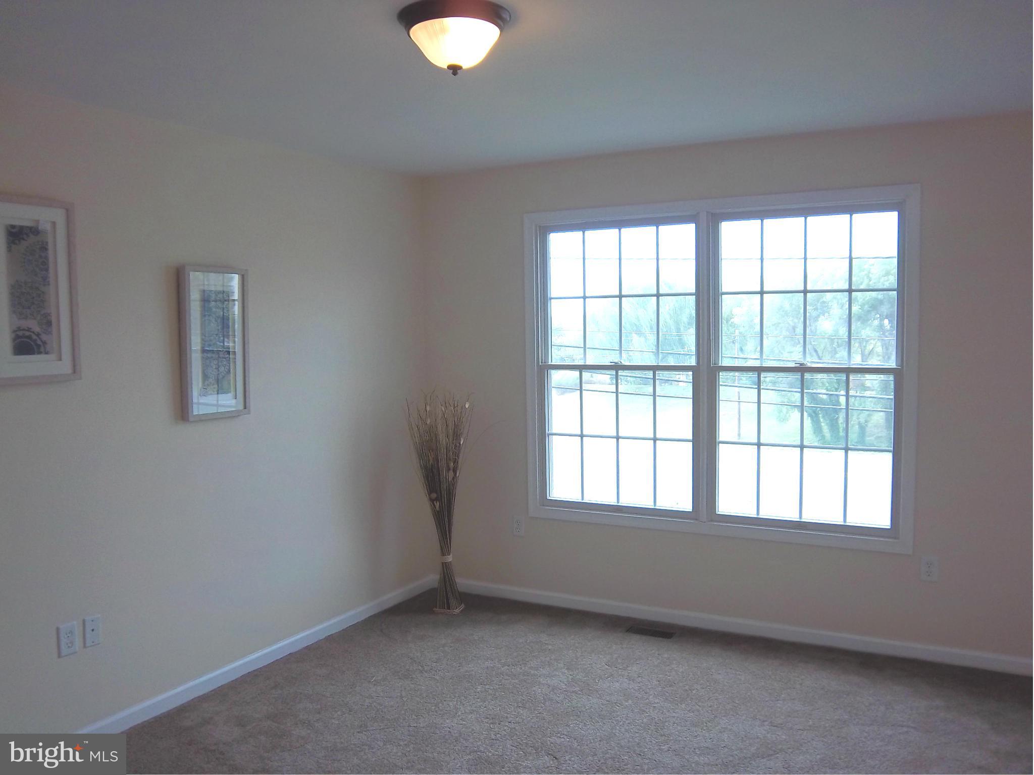 7917 Quarterfield Road Severn, MD 21144 - Photo 9 of 27 a view of an empty room with a window