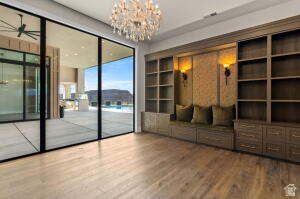 1141 East Lost Ridge Drive Washington, UT 84780 - Photo 51 of 108 Expansive room featuring wood-finish flooring, a built-in shelving system with integrated seating, and large sliding glass doors