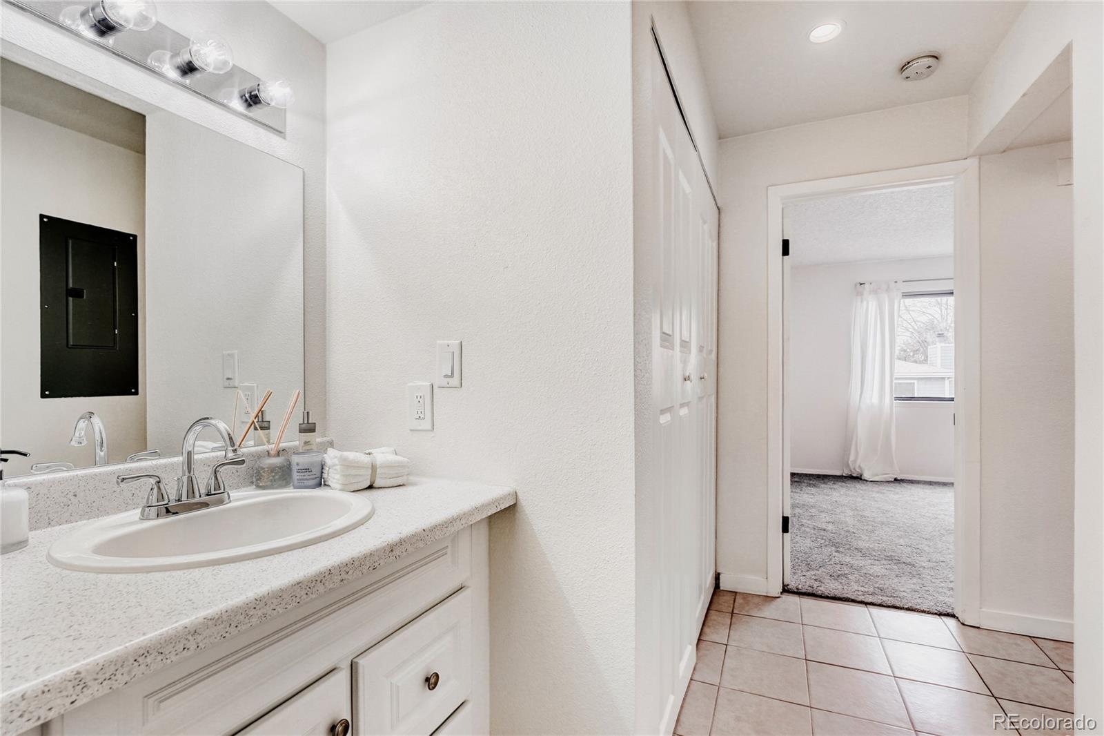 540 South Forest Street, Unit 206 Denver, CO 80246 - Photo 17 of 40 a bathroom with a sink and a mirror