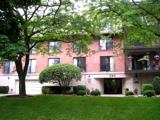 680 Green Bay Road, Unit 209 Winnetka, IL 60093 - Photo 1 of 1 a front view of a house with a garden