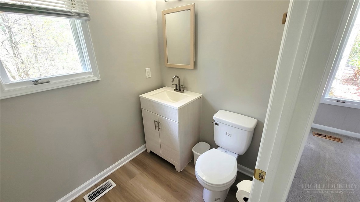 172 Yarrow Lane Boone, NC 28607 - Photo 16 of 30 a bathroom with a toilet sink and mirror