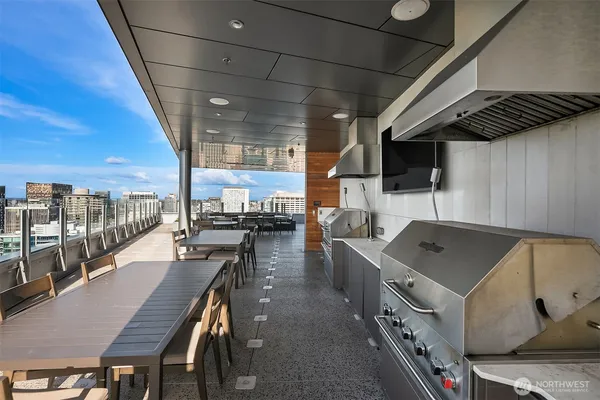 a kitchen with stainless steel appliances granite countertop a sink a stove and a wooden cabinets