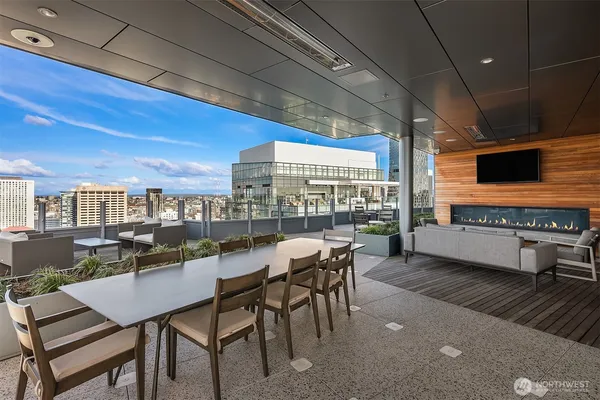 a kitchen with a table chairs and flat screen tv