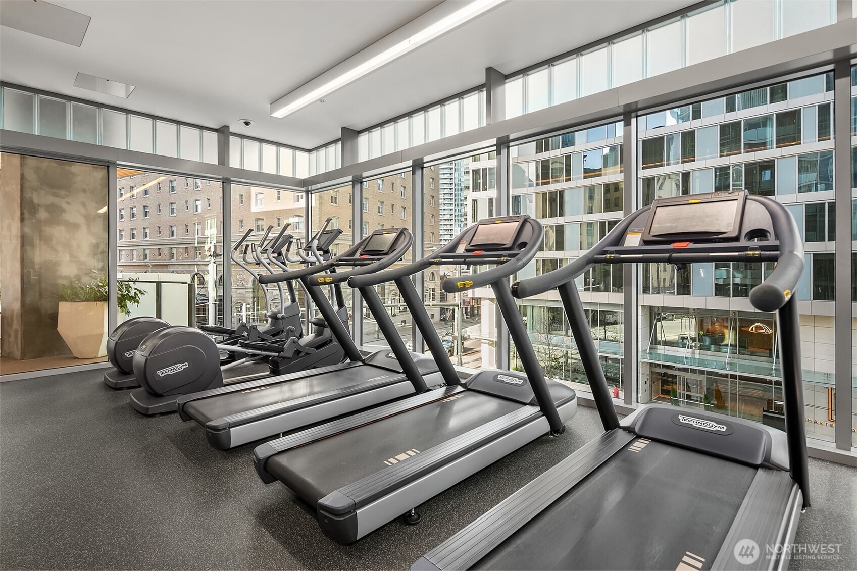 121 Stewart Street, Unit 1304 Seattle, WA 98101 - Photo 23 of 25 a room with gym equipment and a large window