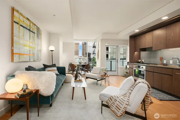 a living room with furniture and a wooden floor