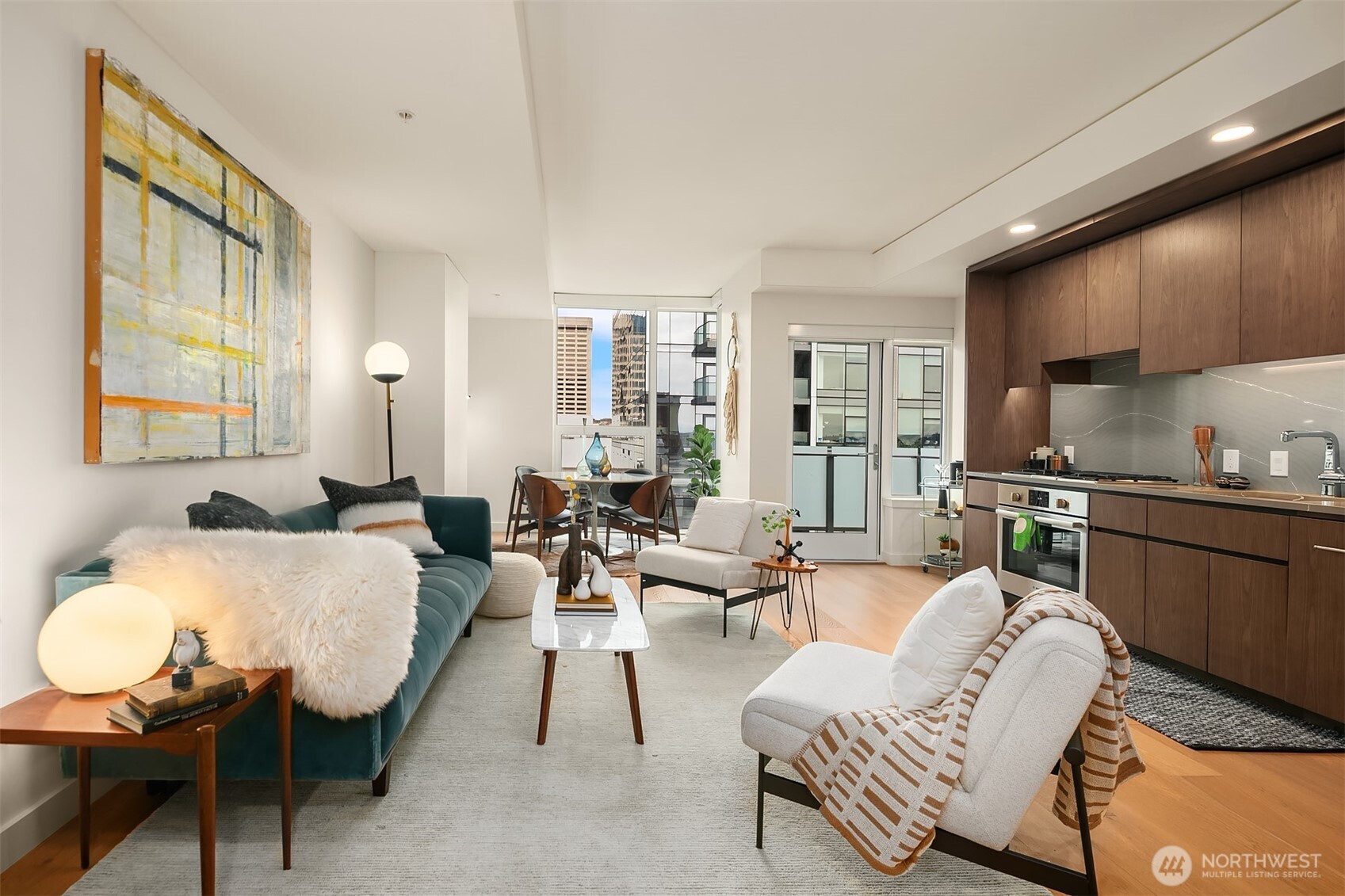 121 Stewart Street, Unit 1304 Seattle, WA 98101 - Photo 3 of 25 a living room with furniture and a wooden floor