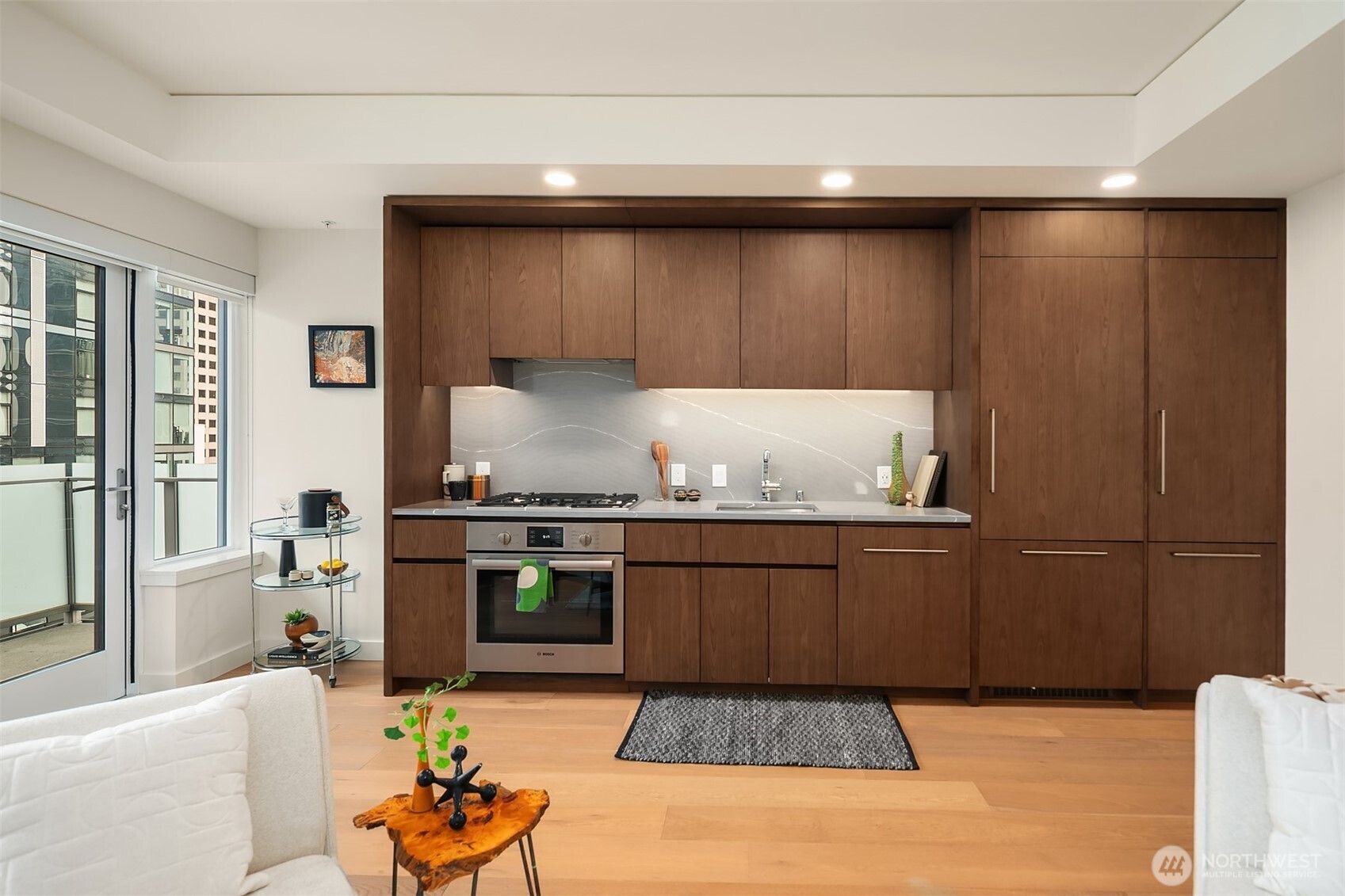 121 Stewart Street, Unit 1304 Seattle, WA 98101 - Photo 7 of 25 a living room with granite countertop furniture and a fireplace