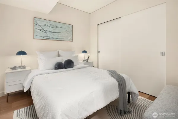 a bedroom with a bed and a painting on the wall
