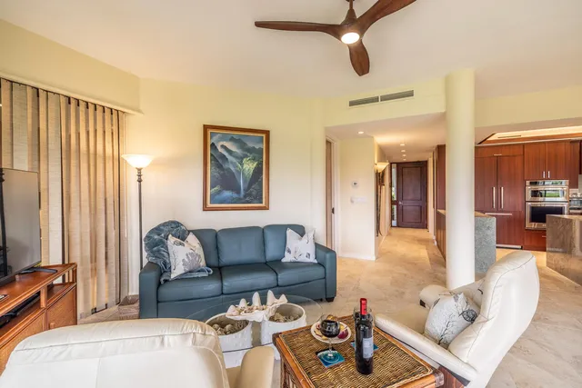 a view of a dining room and livingroom with furniture wooden floor a chandelier
