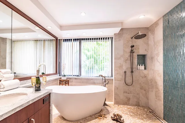 a spacious bathroom with a large tub sink and mirror
