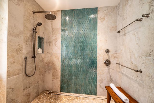 a bedroom with two beds and a chandelier