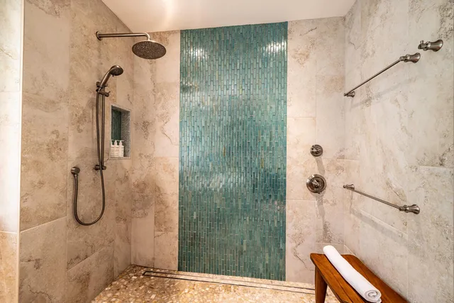 a bedroom with two beds and a chandelier