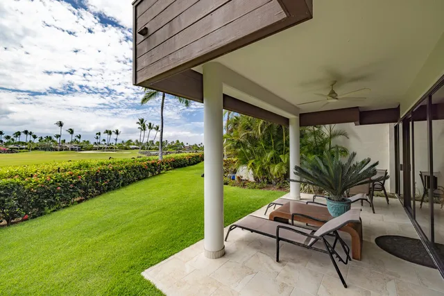 a view of a garden with a bench in front of house