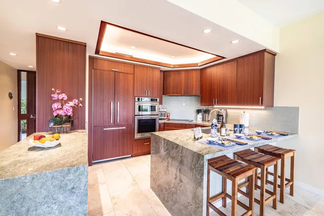 a kitchen with stainless steel appliances a stove a sink a stove and cabinets