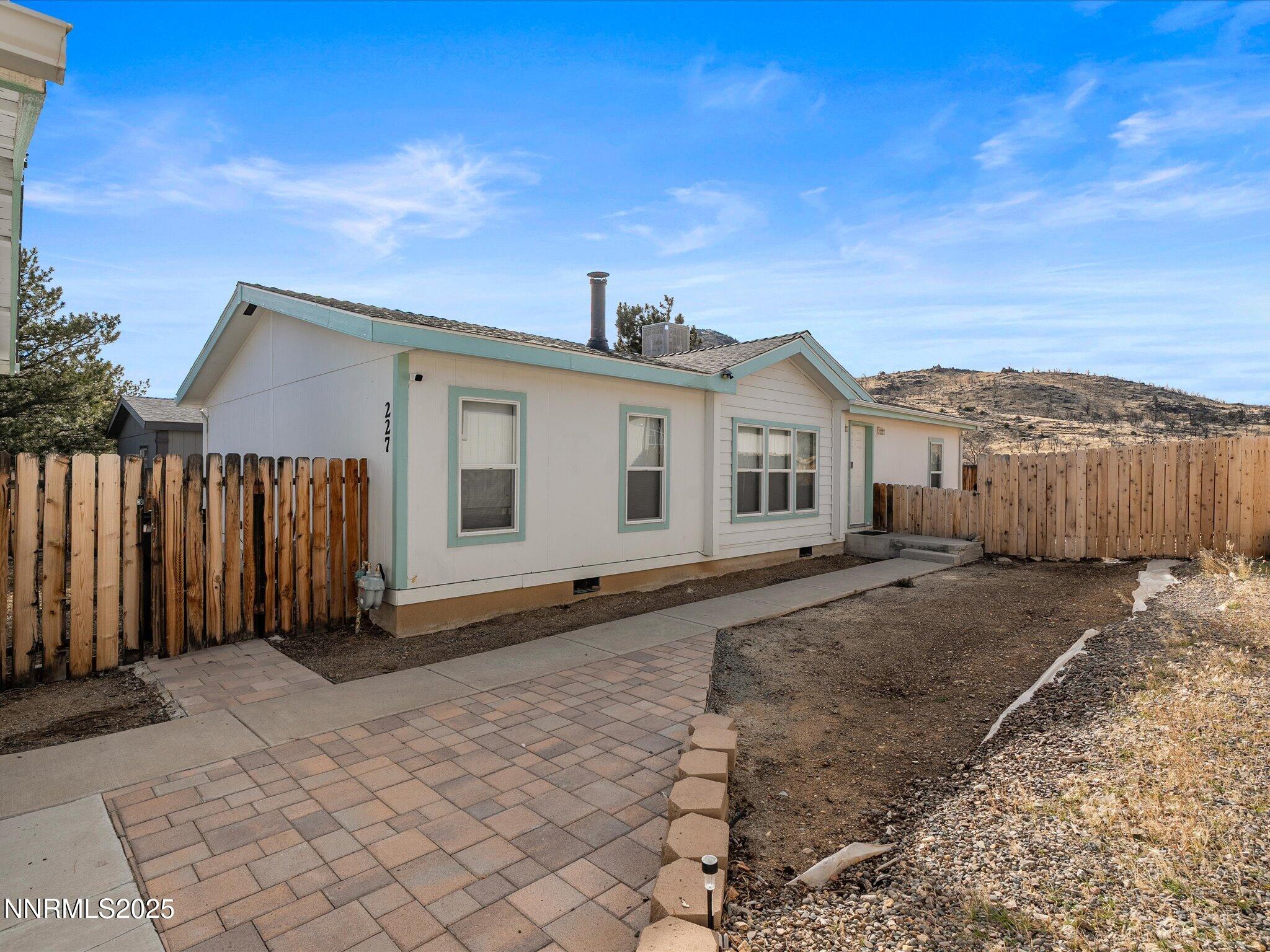 a view of a house with wooden fence