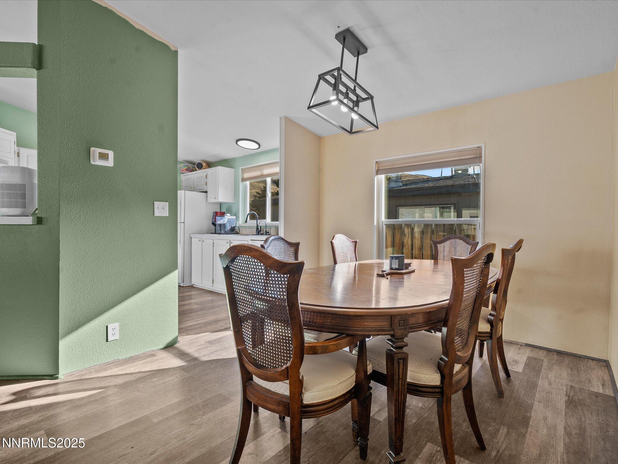 227 Walker Street Gardnerville, NV 89410 - Photo 11 of 33 a view of a dining room with furniture and wooden floor