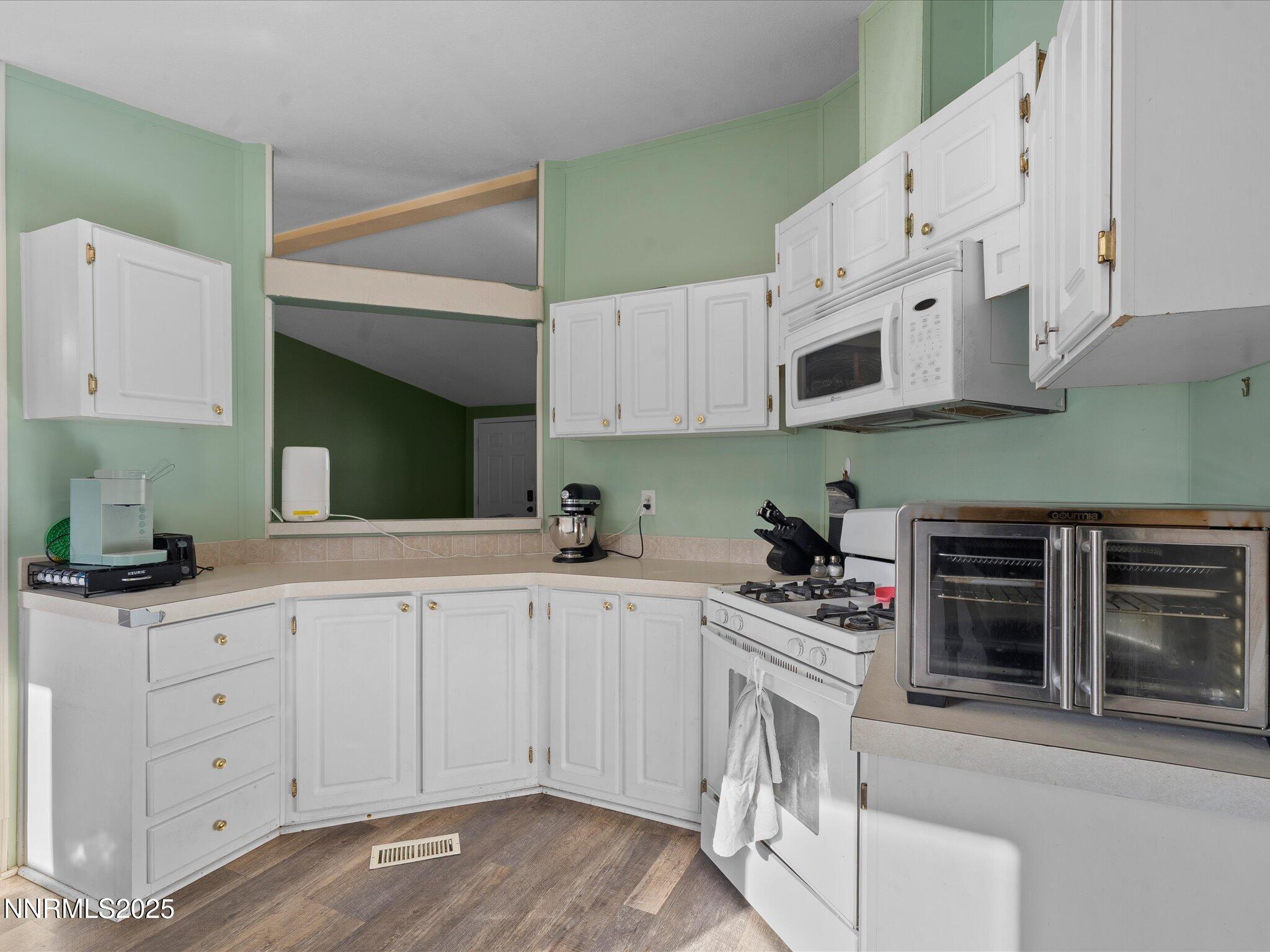 227 Walker Street Gardnerville, NV 89410 - Photo 13 of 33 a kitchen with granite countertop a sink and cabinets
