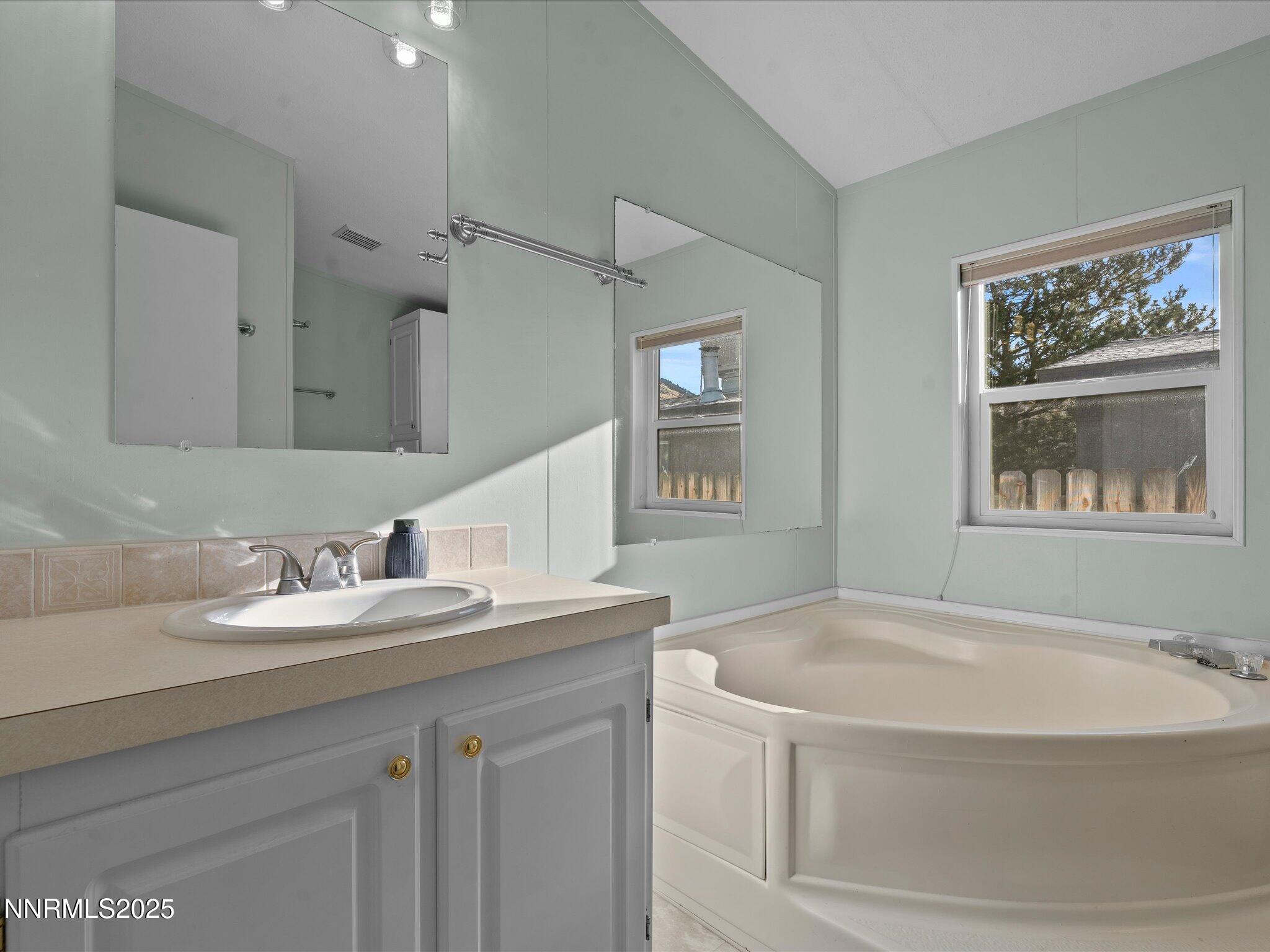 227 Walker Street Gardnerville, NV 89410 - Photo 19 of 33 a bathroom with a granite countertop sink and a mirror