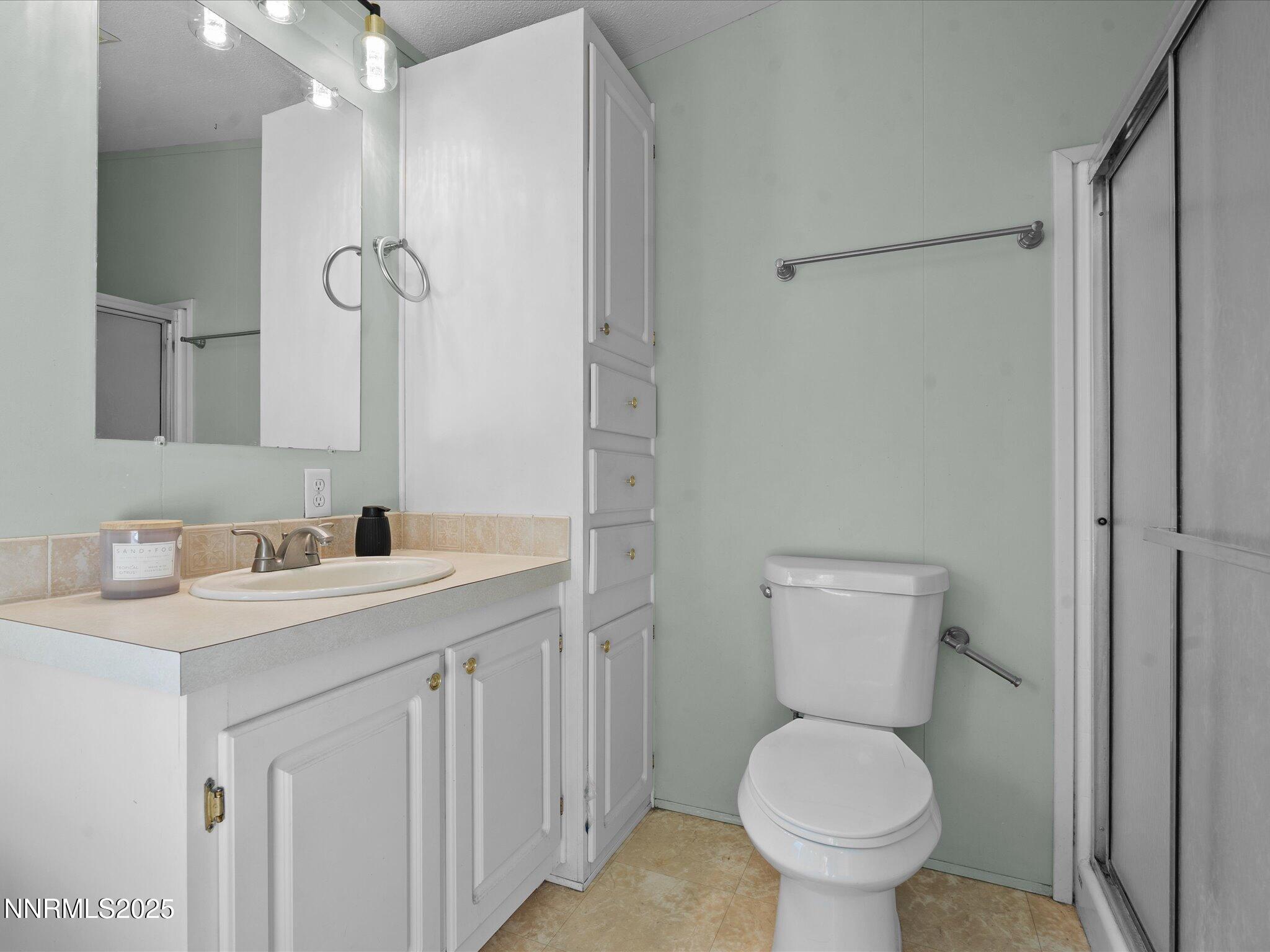 227 Walker Street Gardnerville, NV 89410 - Photo 22 of 33 a bathroom with a toilet sink and mirror