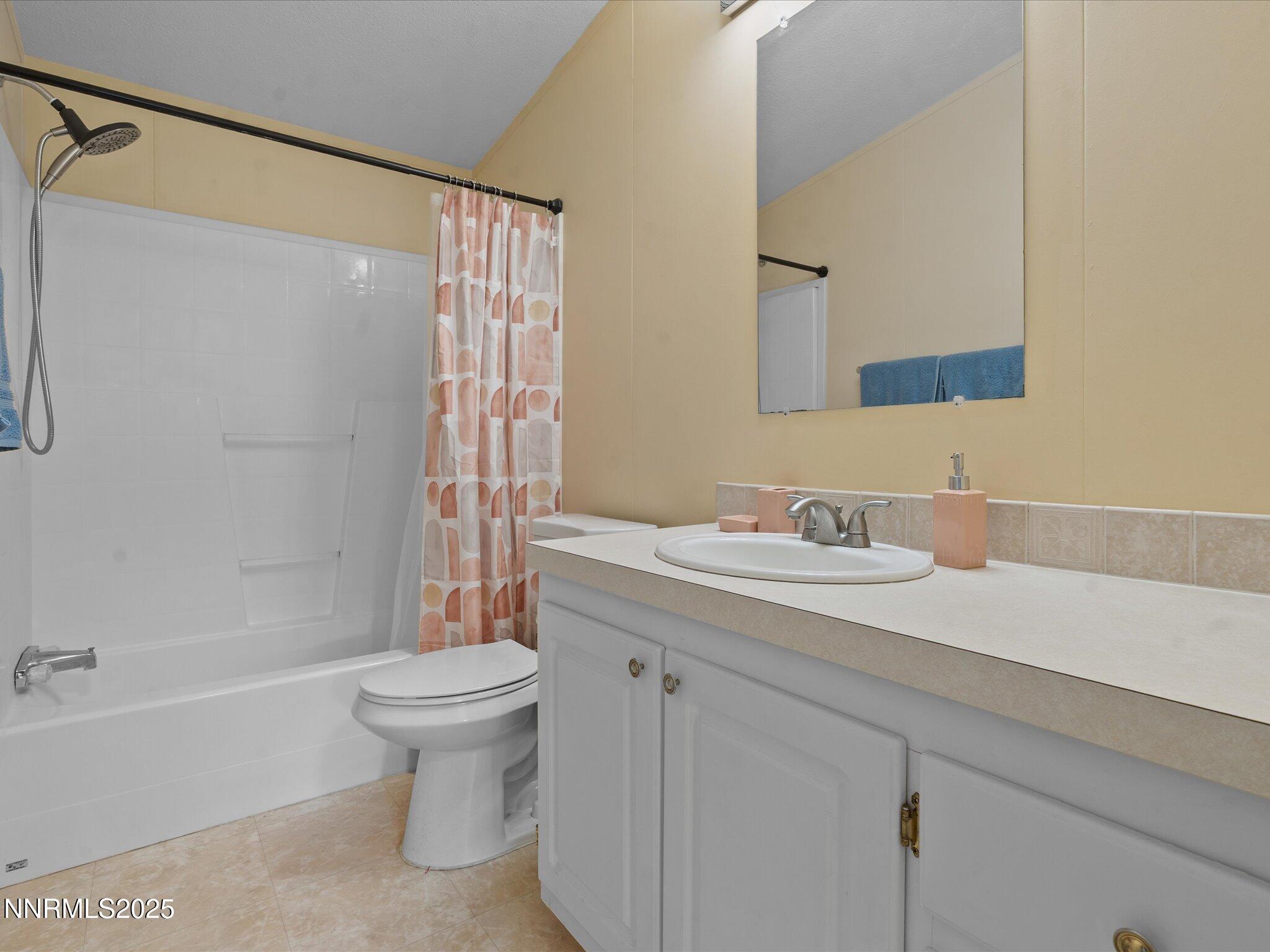 227 Walker Street Gardnerville, NV 89410 - Photo 24 of 33 a bathroom with a granite countertop sink a toilet and shower