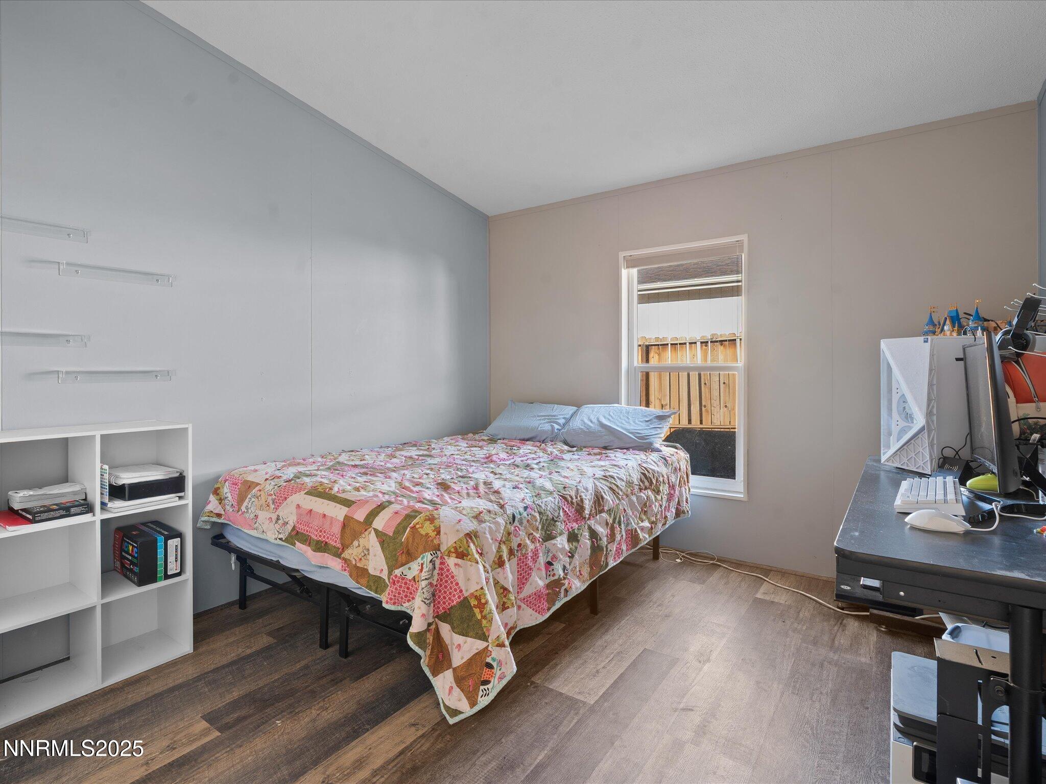 227 Walker Street Gardnerville, NV 89410 - Photo 25 of 33 a bedroom with a bed and a flat screen tv