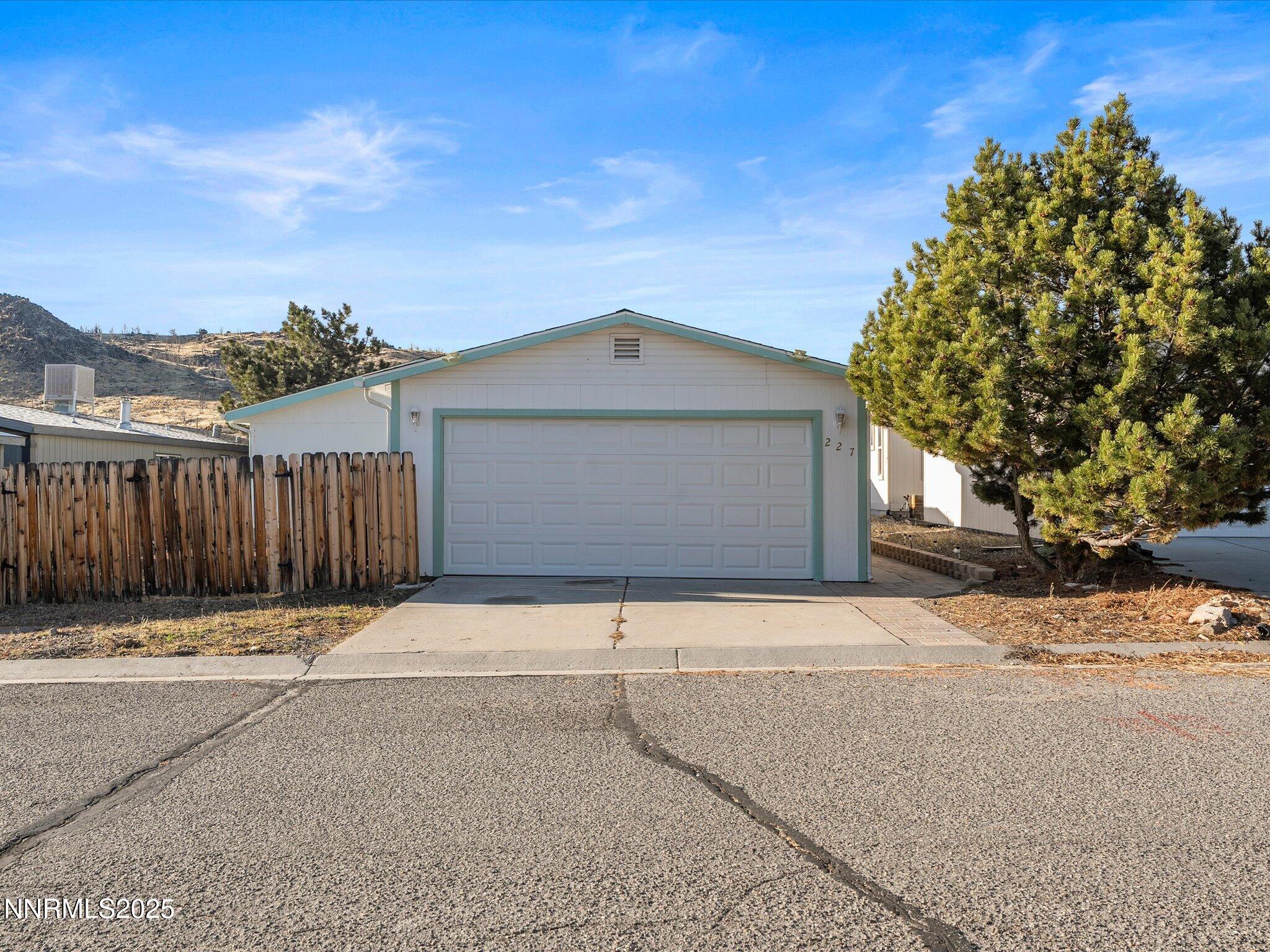 227 Walker Street Gardnerville, NV 89410 - Photo 3 of 33 a front view of a house with a yard and garage